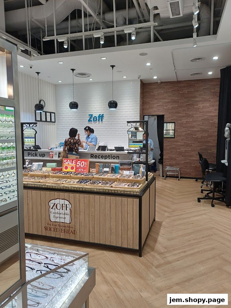 Interior of a Zoff eyewear shop with displays of glasses and a reception area.