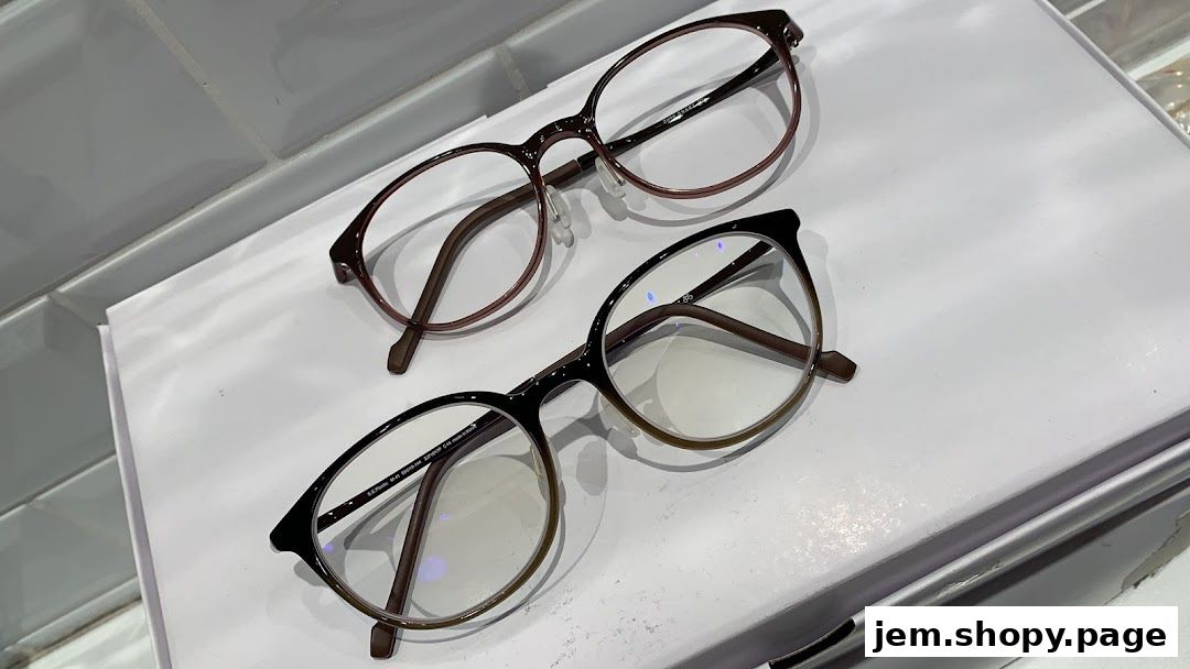Two pairs of stylish eyeglasses, one maroon and one black, displayed on a white surface.