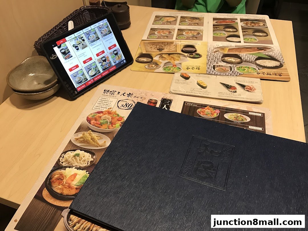 A table at Watami Japanese Dining with a tablet menu and food pictures.