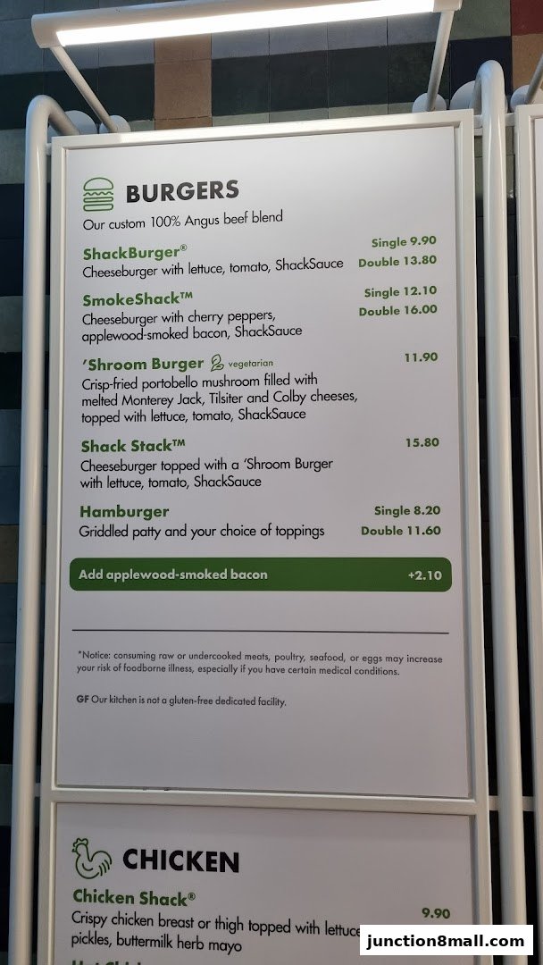 A menu board displaying burgers and chicken items with prices.