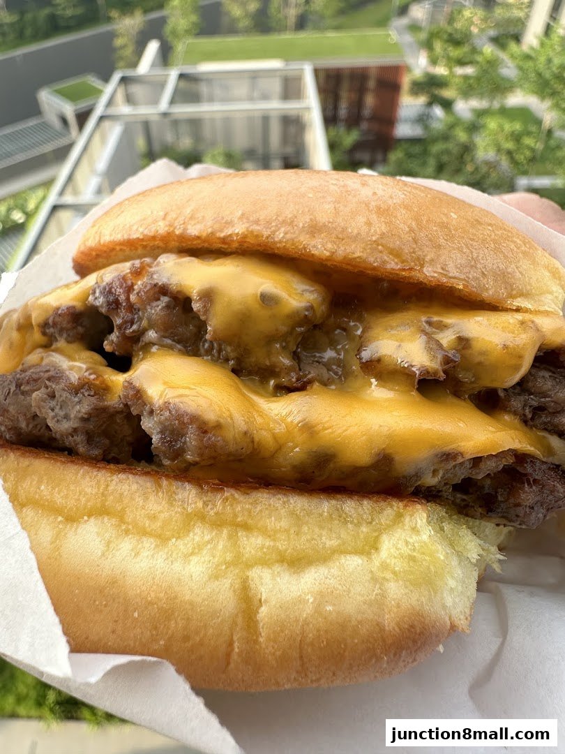 A close-up shot of a juicy double cheeseburger with melted cheese.