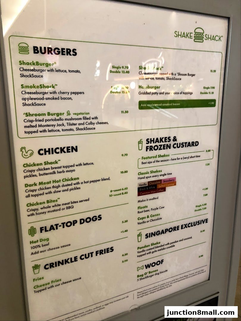 A menu board for Shake Shack featuring burgers, chicken, hot dogs, fries, shakes, and Singapore exclusives.