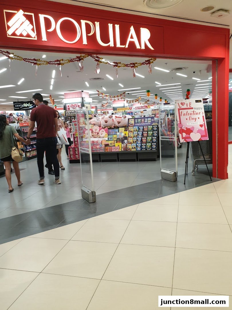 Entrance to POPULAR Bookstore with people browsing inside and Valentine's Day decorations.