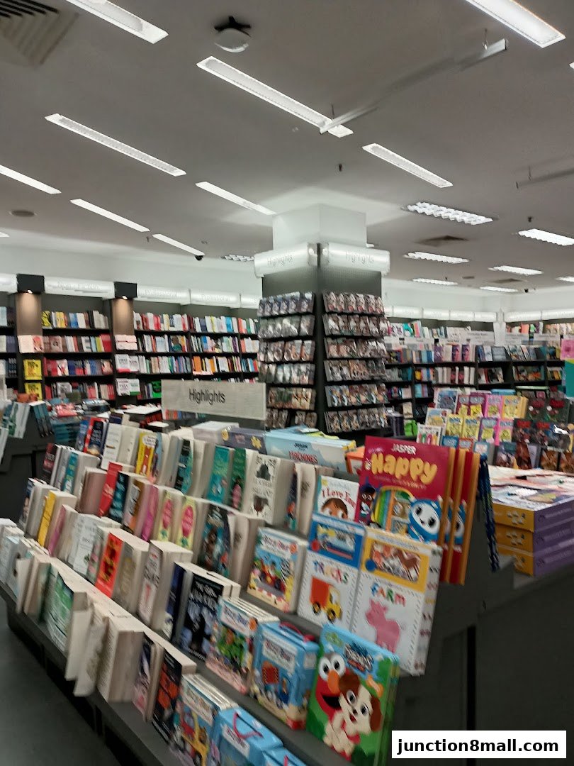 Interior view of a POPULAR Bookstore with shelves full of books and children's books on display.