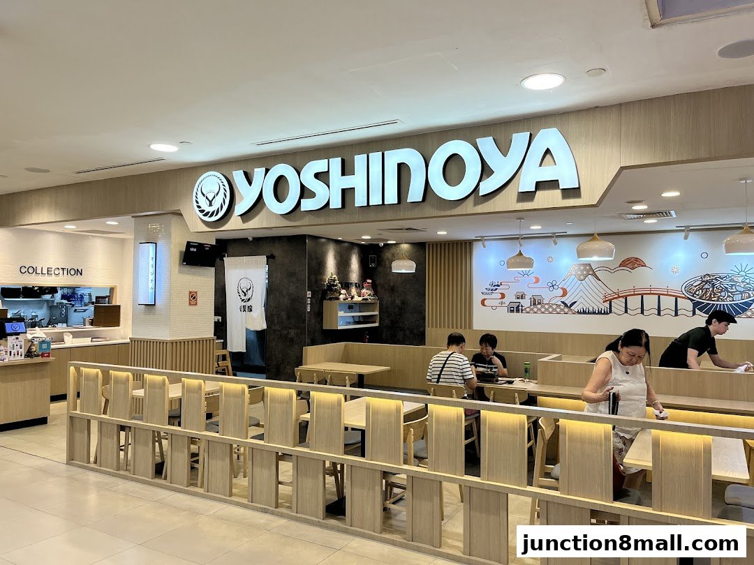 The Yoshinoya restaurant interior with customers dining and staff working.
