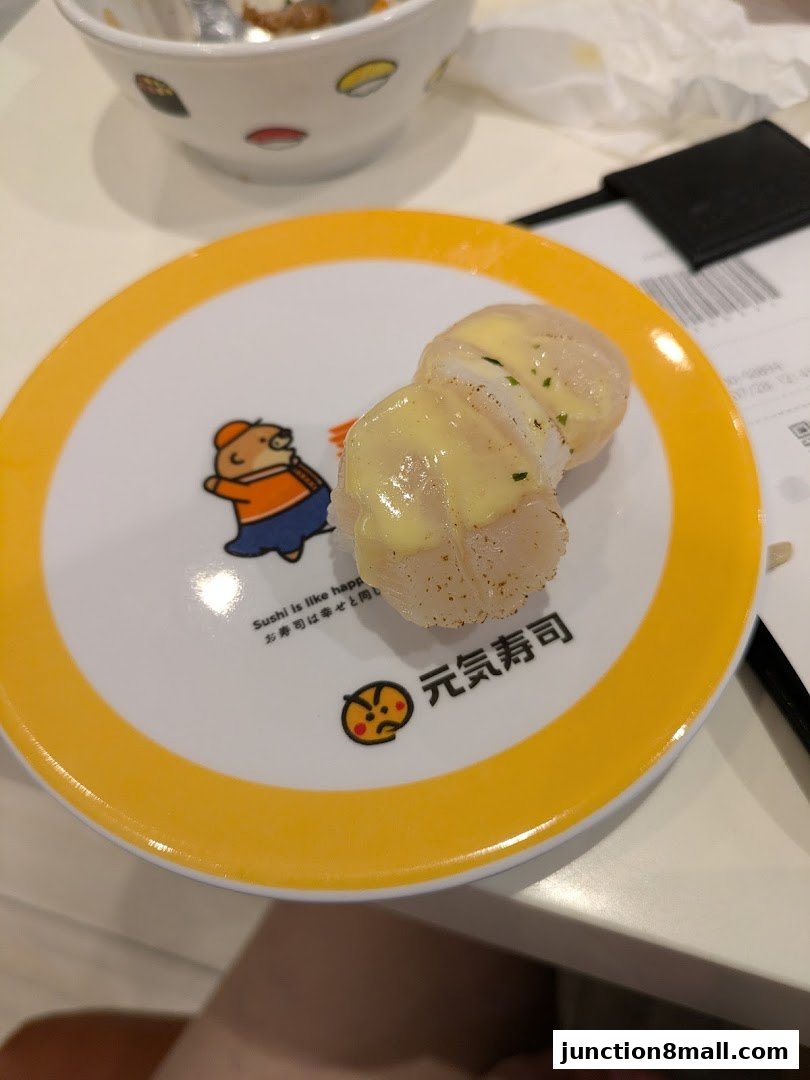 A plate of sushi with sauce on it, from Genki Sushi Junction 8.