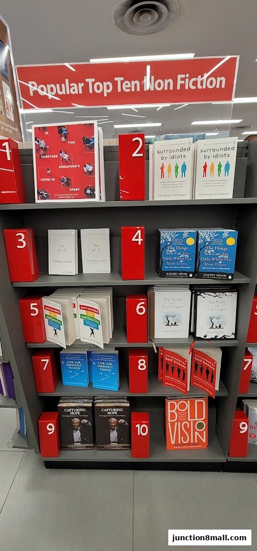 A display of books at Popular Bookstore, featuring a 'Top Ten Non Fiction' section with numbered book placements.