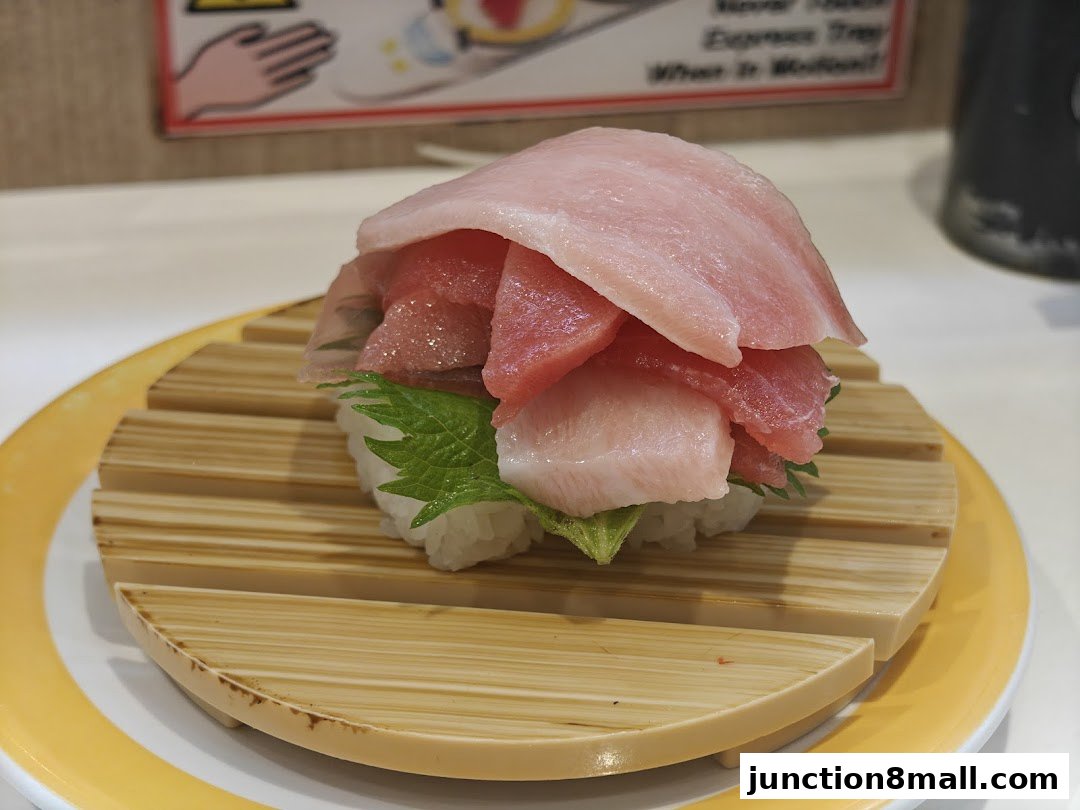 A close-up of a sushi dish with multiple slices of tuna on top of rice.