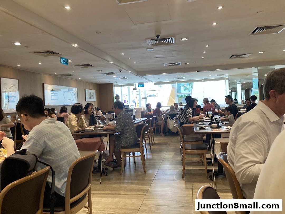 Interior view of a busy restaurant with many diners seated at tables.