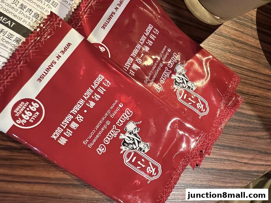 Two red packets labeled 'Dian Xiao Er' with text about crispy juicy herbal roast duck.