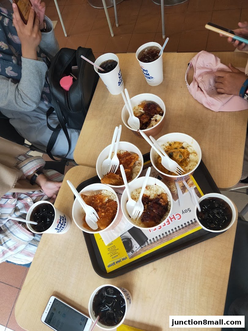 A table laden with Long John Silver's meals, drinks, and people enjoying their food.