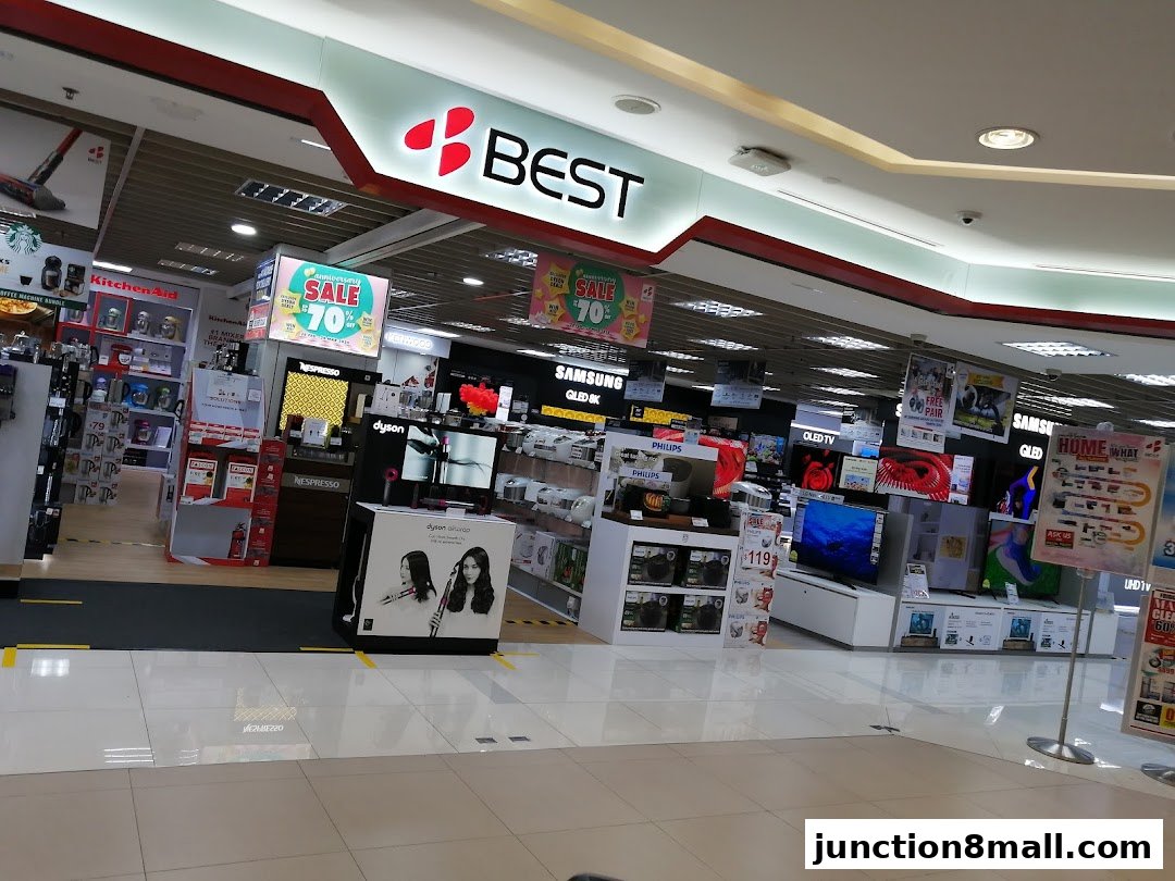 Interior view of a Best Denki electronics store showcasing various brands and sale promotions.