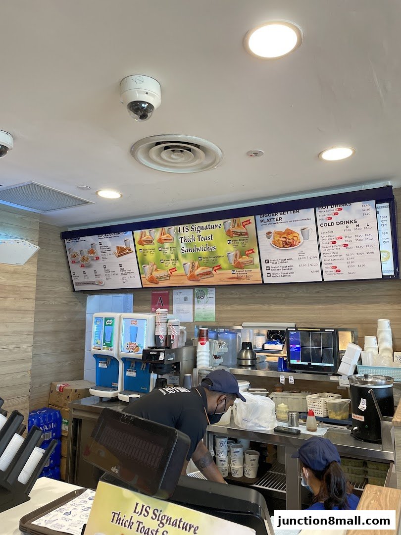 Staff working behind the counter at Long John Silvers with a menu board above.
