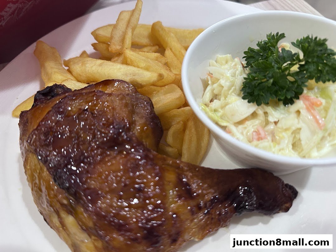 A plate of Swensen's chicken with fries and coleslaw, garnished with parsley.
