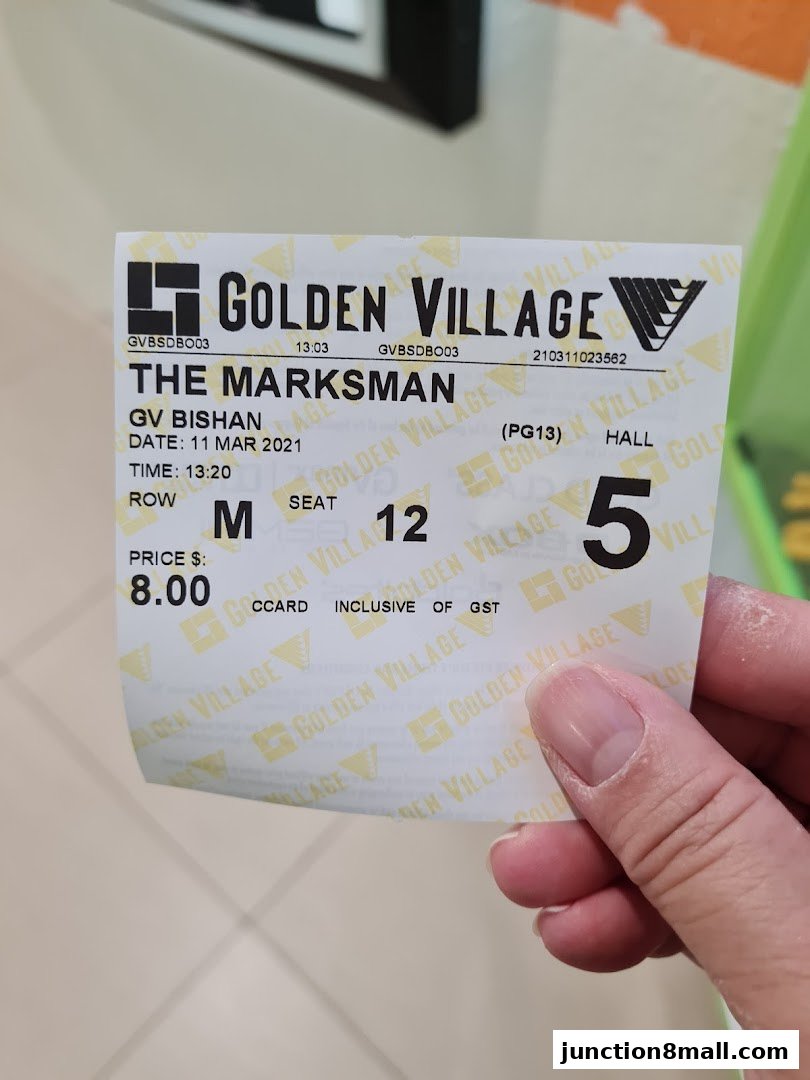 A hand holds a Golden Village cinema ticket for 'The Marksman' movie at GV Bishan.