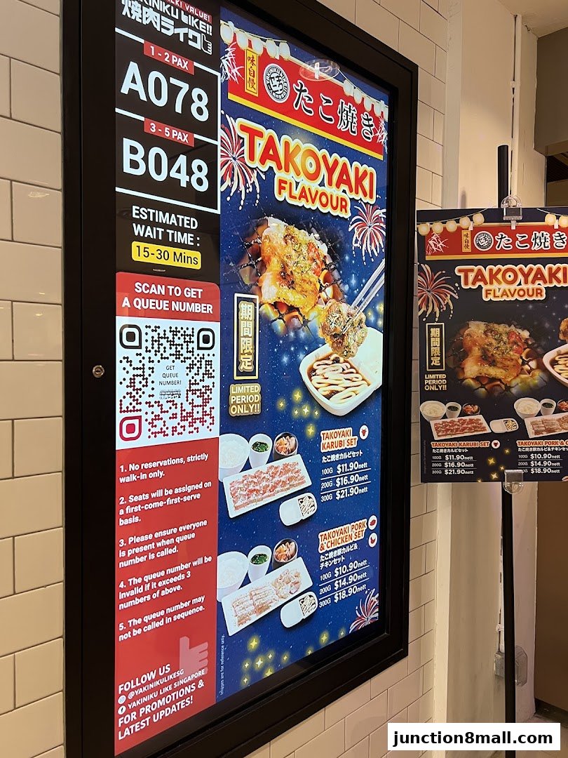 A digital display shows queue numbers, estimated wait time, and promotional images of Takoyaki sets.