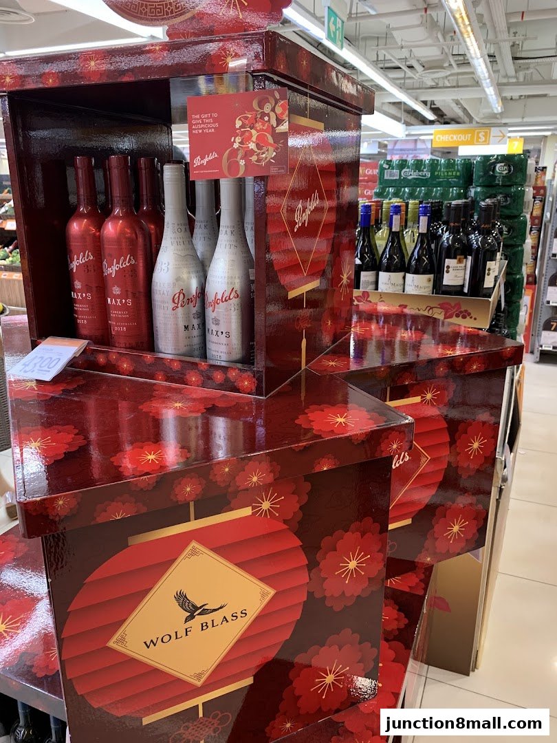 A display of Penfolds and Wolf Blass wine bottles in festive red packaging.