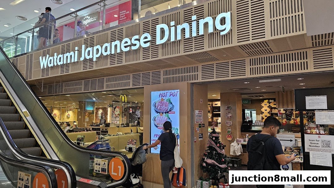 The exterior of Watami Japanese Dining with an escalator and a digital menu display.