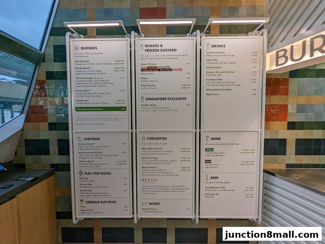 A menu board displaying burgers, shakes, drinks, chicken, hot dogs, fries, concretes, wine, and beer.