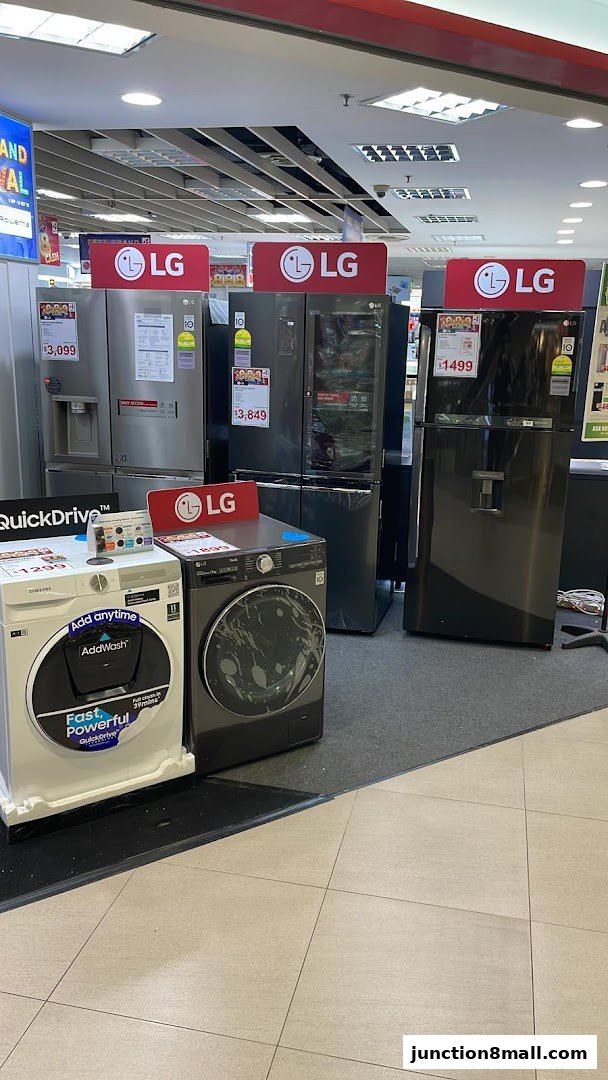 A display of LG refrigerators and Samsung washing machines with prices.