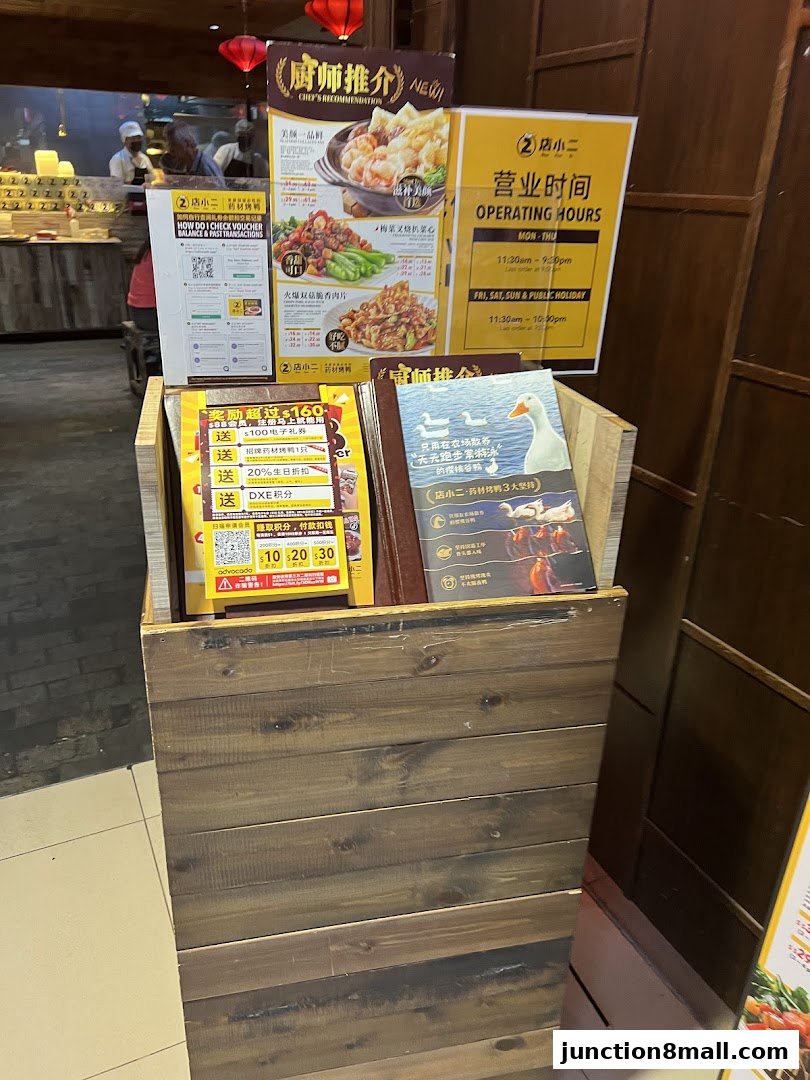 A display stand with menus and promotional flyers for Dian Xiao Er Junction 8.