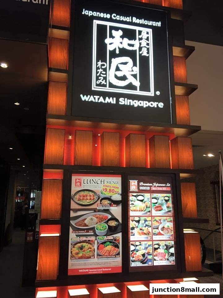 The exterior signage and illuminated menu displays of Watami Japanese Casual Restaurant.