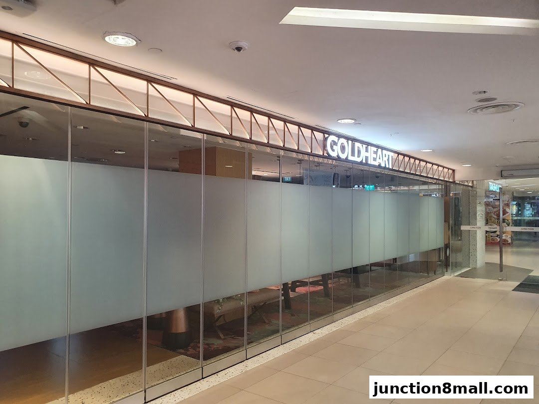 The exterior of the Goldheart Jewelry store at Junction 8, featuring frosted glass panels and a prominent sign.