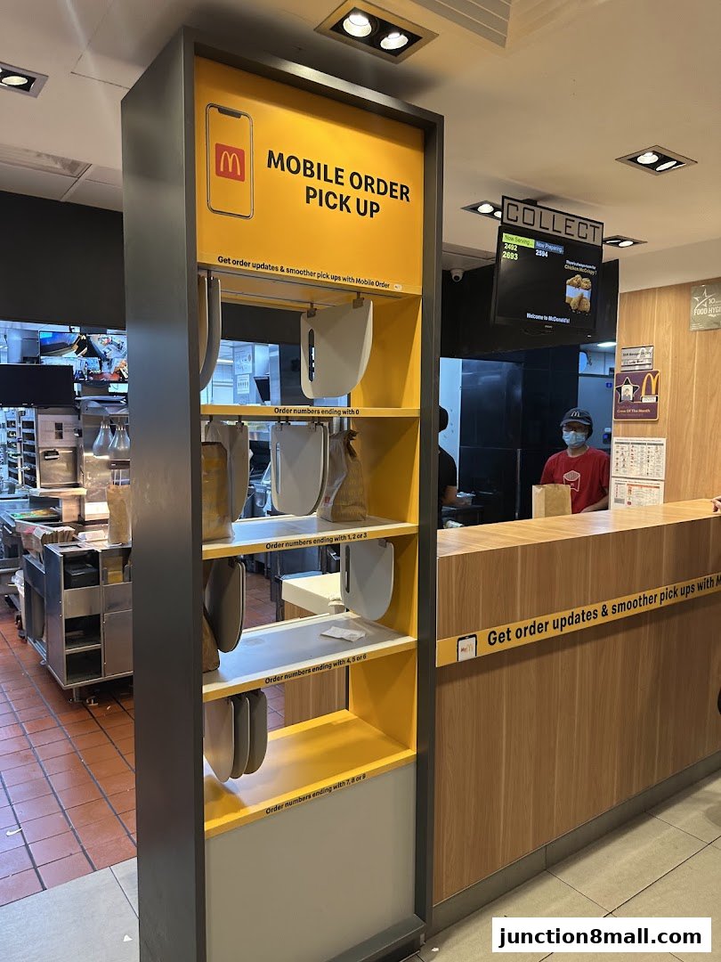McDonald's mobile order pick-up counter with designated shelves for orders.
