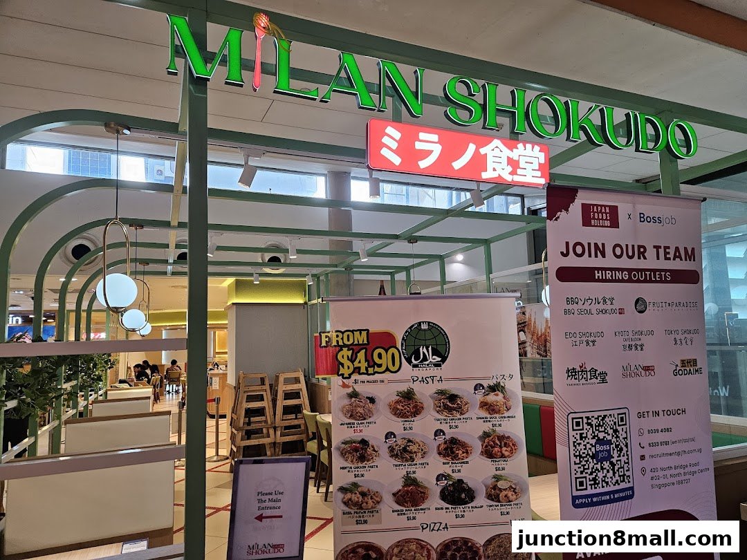 The exterior of Milan Shokudo Junction 8, a Japanese restaurant with a hiring advertisement.