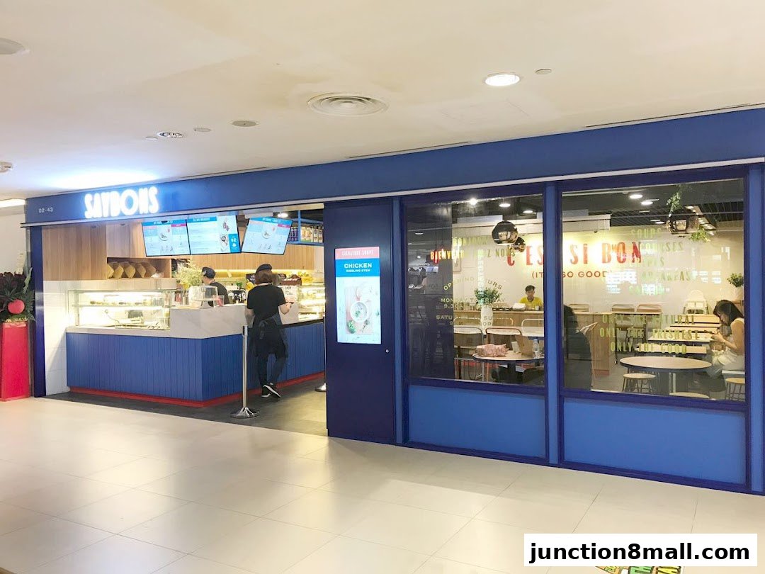 The Saybons shop front with a blue and white facade, displaying food items and seating inside.