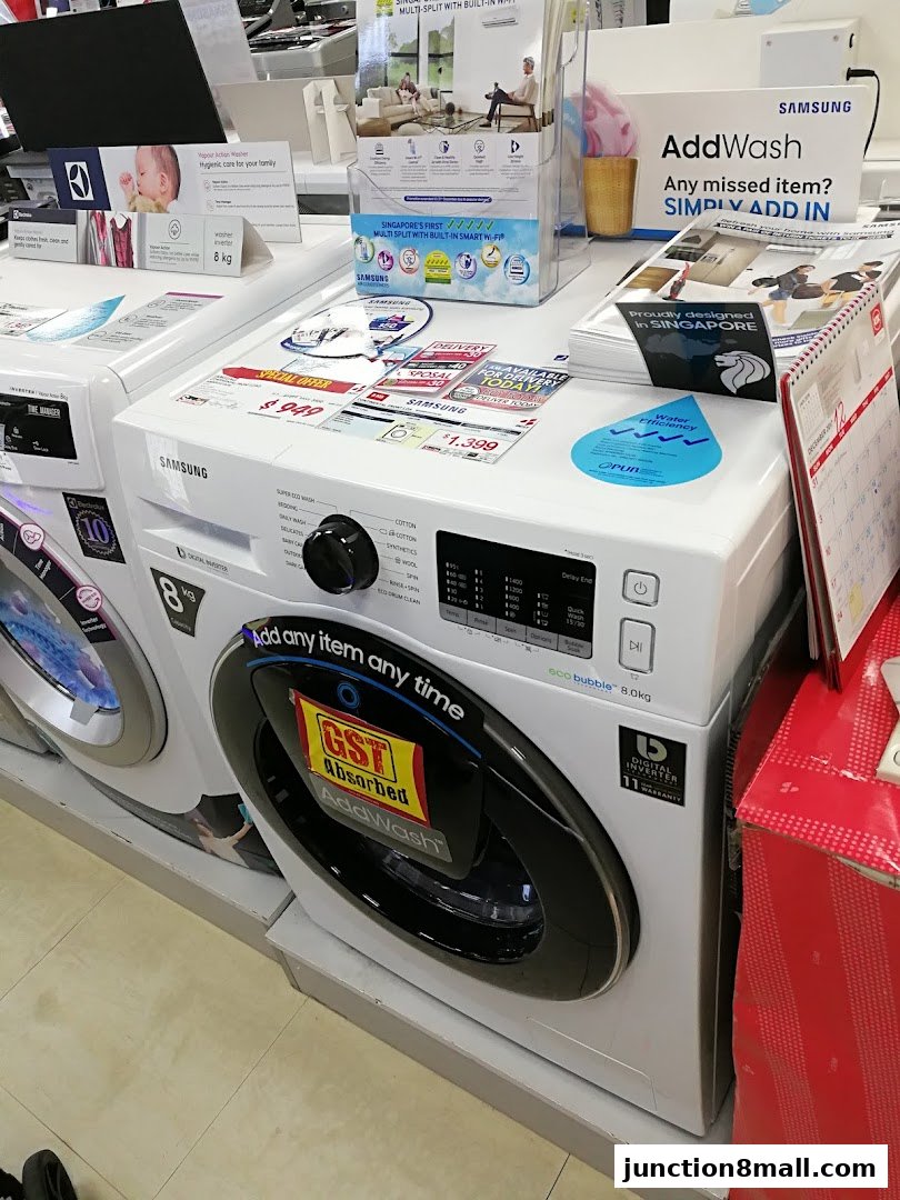 Samsung washing machines with AddWash feature displayed in a retail store.
