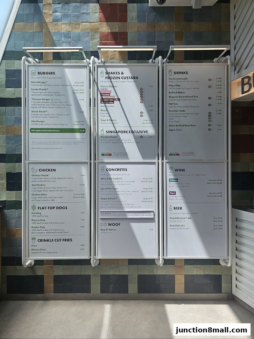 A menu board displaying burgers, shakes, frozen custard, drinks, chicken, hot dogs, fries, concretes, wine, and beer.