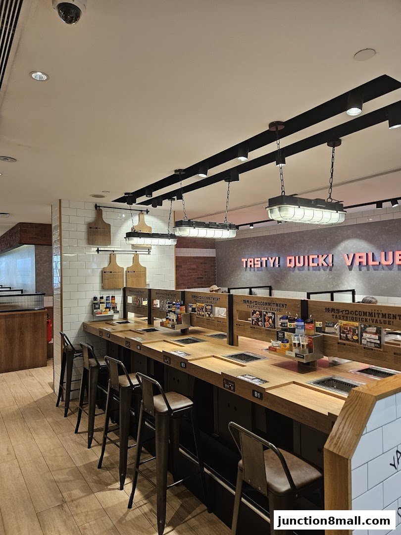 Interior of a Yakiniku Like restaurant with individual grilling stations and bar seating.