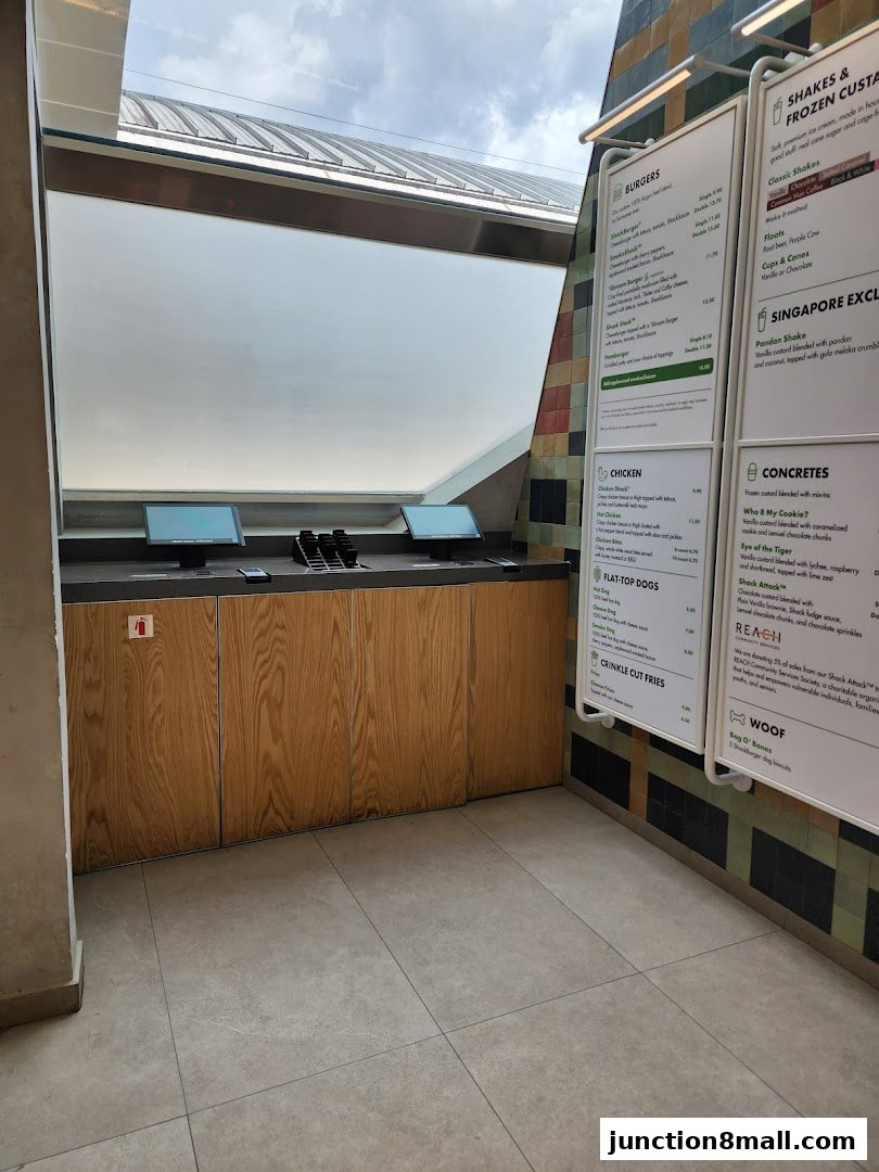 A menu board displaying burgers, chicken, fries, shakes, and concretes at Shake Shack.