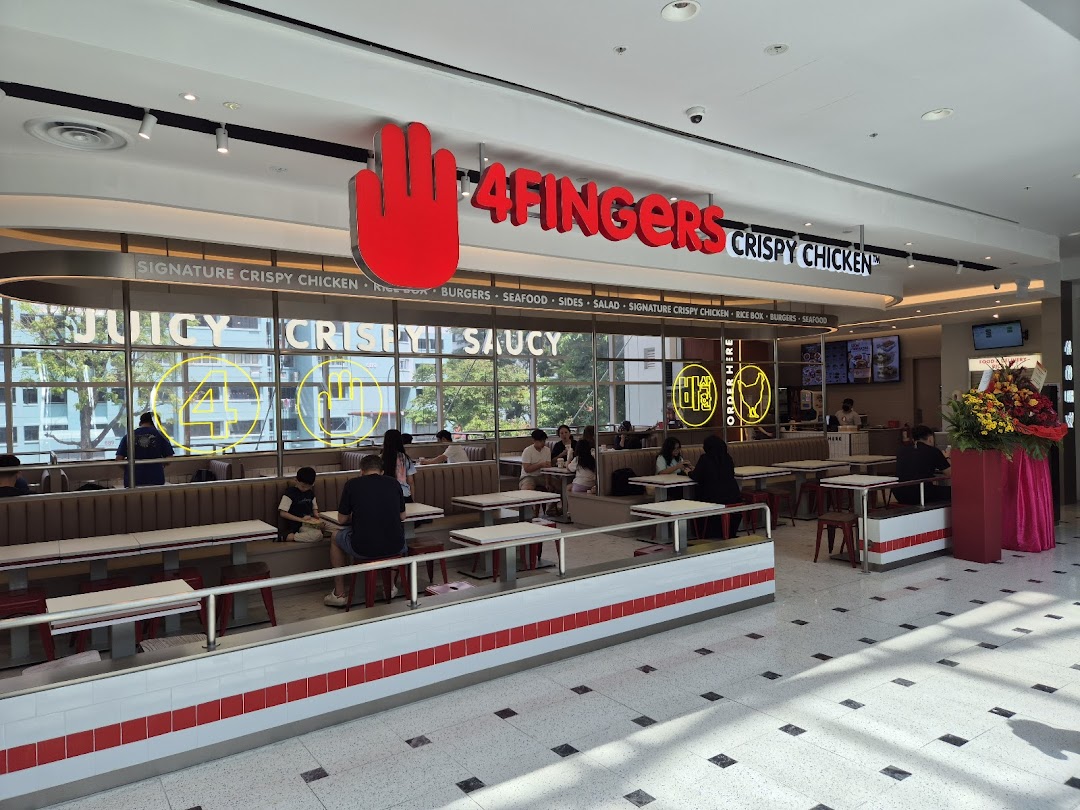 An inviting interior view of 4Fingers Crispy Chicken, featuring its dining area and prominent branding.