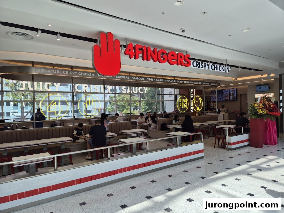 An inviting interior view of 4Fingers Crispy Chicken, featuring its dining area and prominent branding.