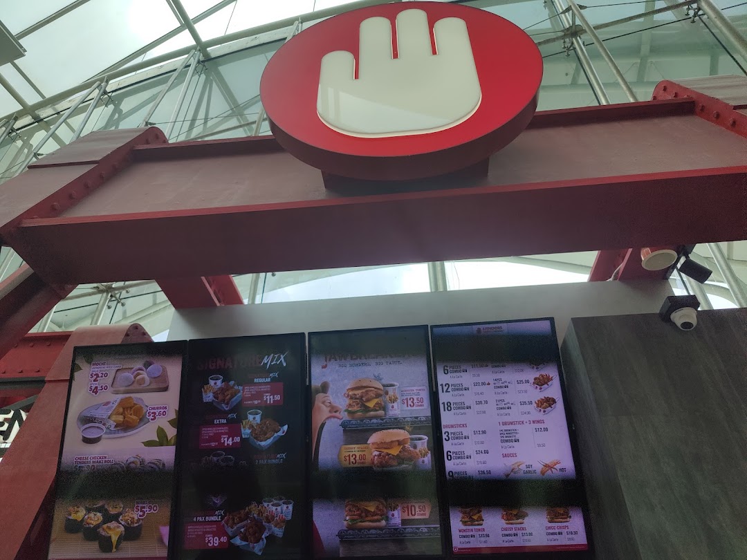 Digital menu boards displaying various chicken meals, burgers, and sides at 4Fingers Crispy Chicken.