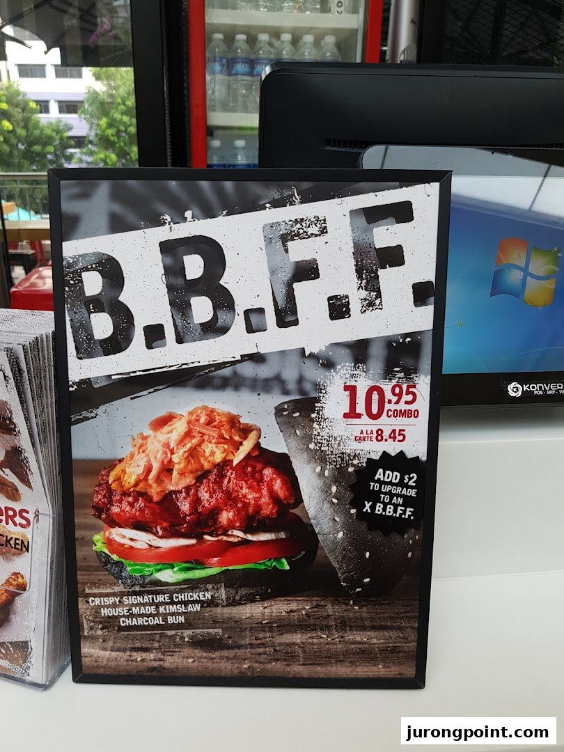 A promotional standee for 4Fingers Crispy Chicken's B.B.F.F. burger, detailing its ingredients and pricing.