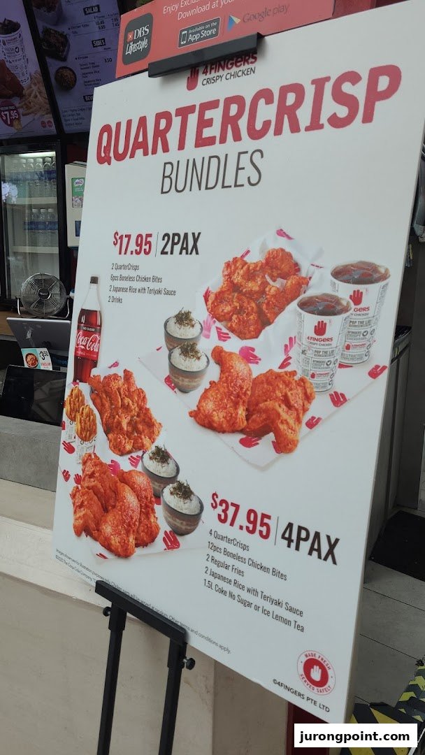 A promotional stand displaying QuarterCrisp Bundles and prices for 4Fingers Crispy Chicken.