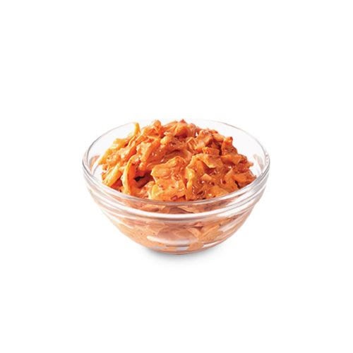 A clear glass bowl filled with orange-colored coleslaw or a similar shredded vegetable side dish.