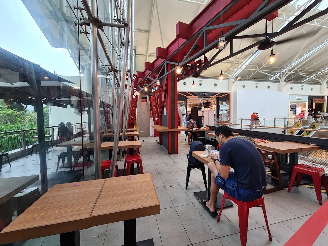 Diners enjoy a spacious, modern seating area with mall and outdoor views at 4Fingers Crispy Chicken.