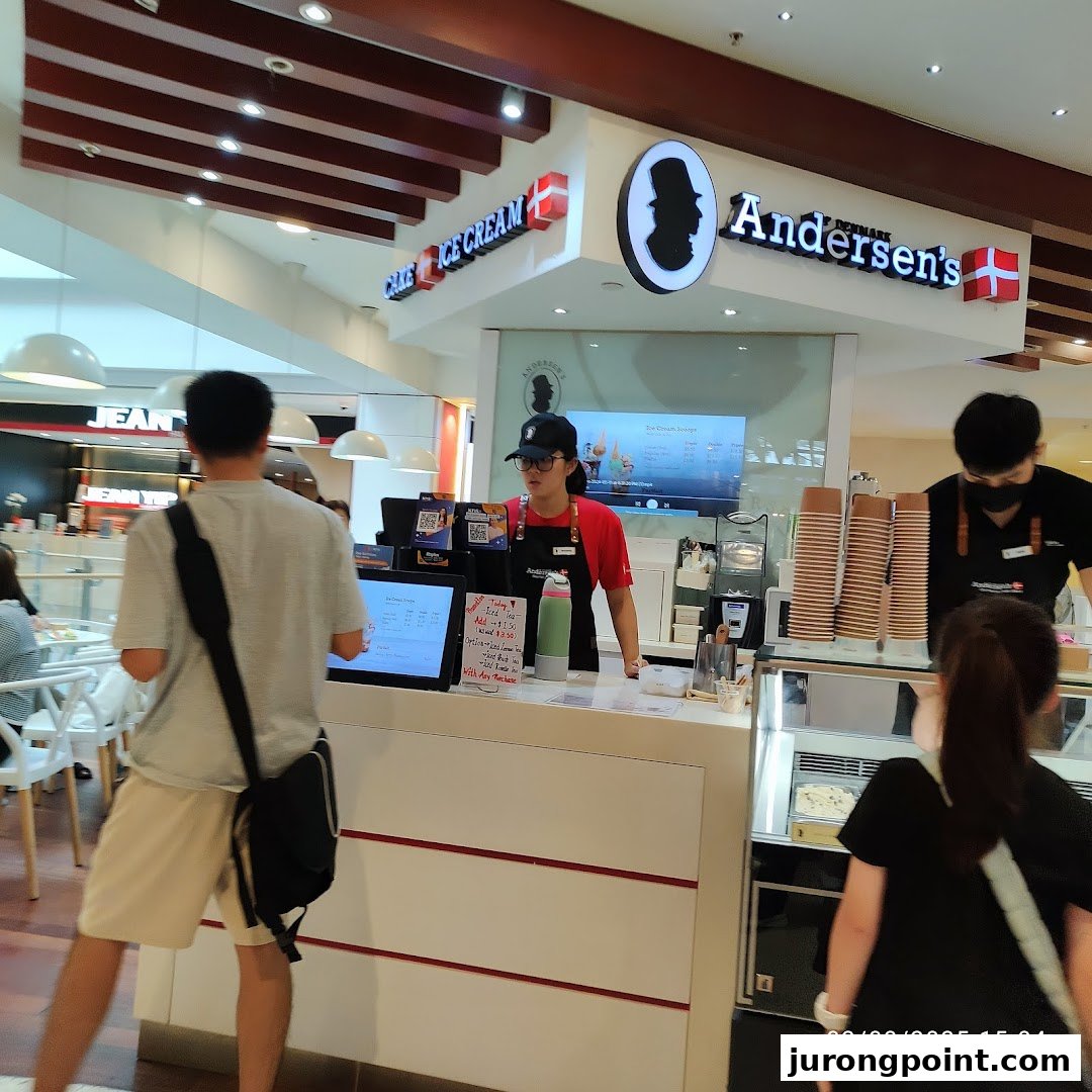 Interior view of Andersen's ice cream shop with staff serving customers at the counter.