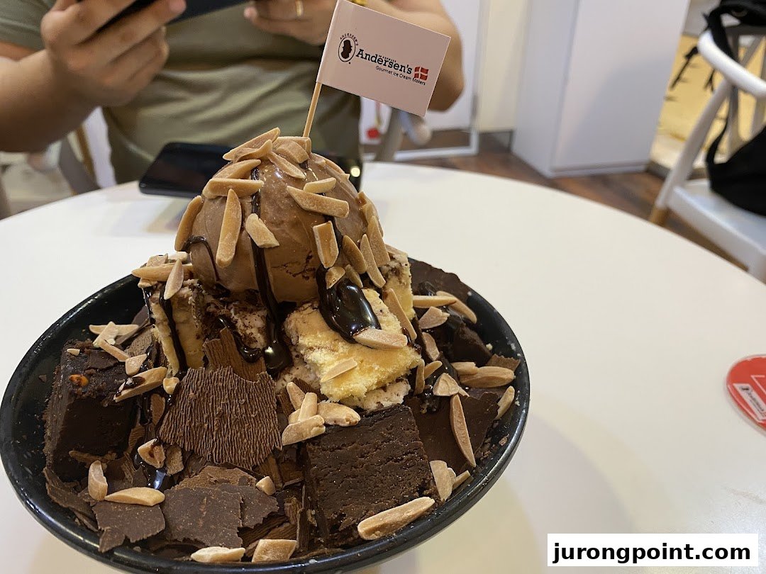 A decadent chocolate ice cream sundae with brownies, chocolate shards, and almonds from Andersens of Denmark.
