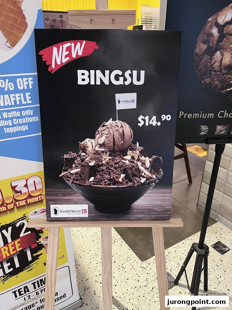 A promotional display board showcasing a new chocolate Bingsu dessert with ice cream and toppings for $14.90.