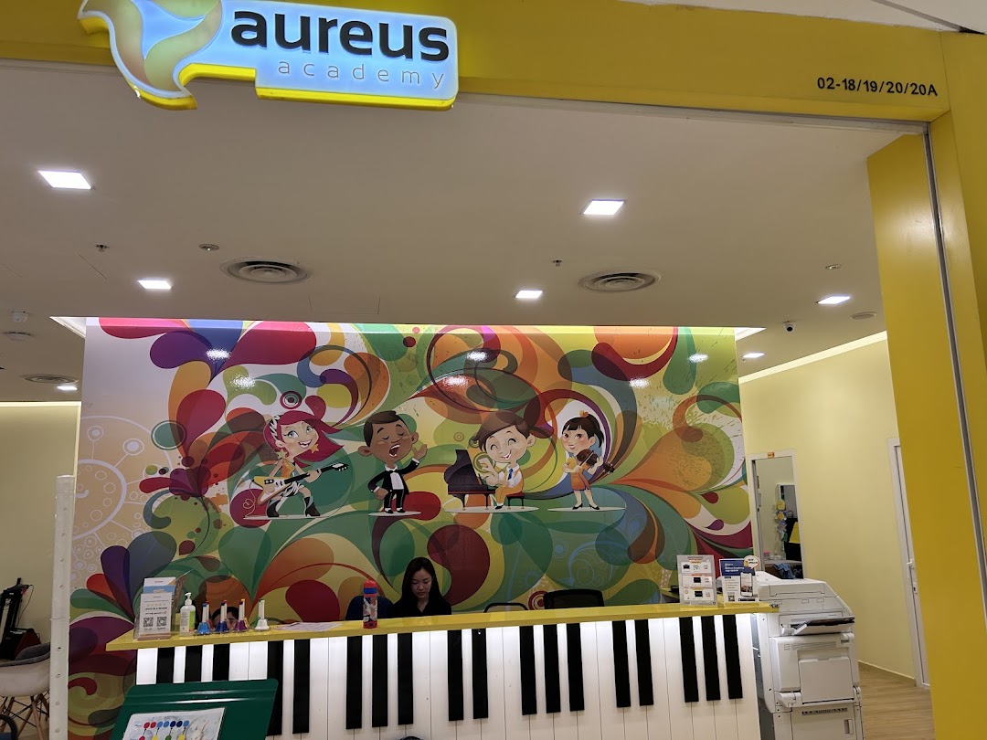 Vibrant reception area of Aureus Academy, featuring a piano-themed counter and colorful musical artwork.