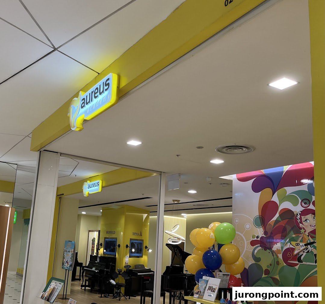 The bright yellow entrance of Aureus Academy, showcasing musical instruments and a vibrant interior.