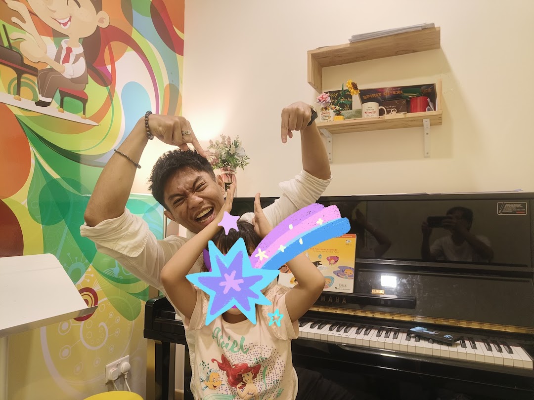An adult and child playfully pose in a vibrant music academy room with a piano.