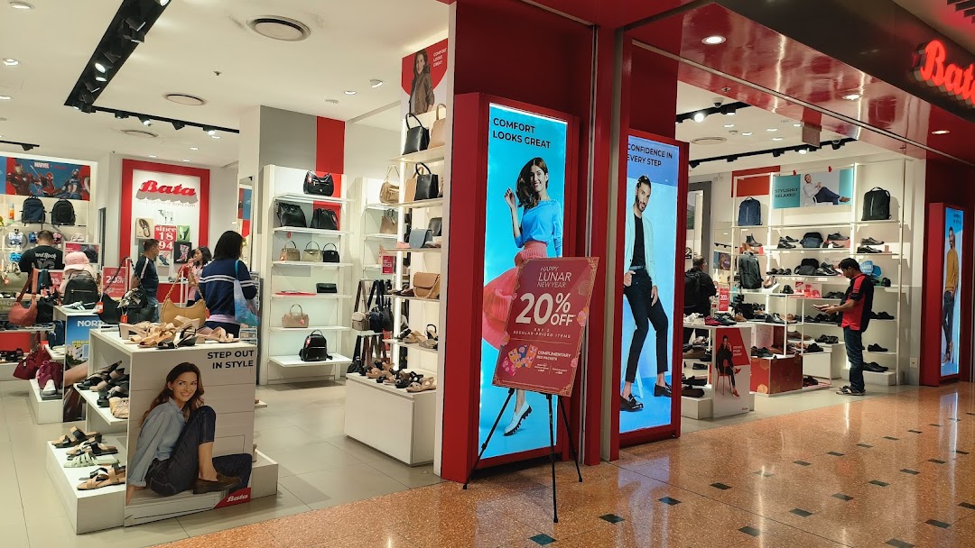 Interior view of Bata store showcasing shoes, bags, and accessories with customers browsing.