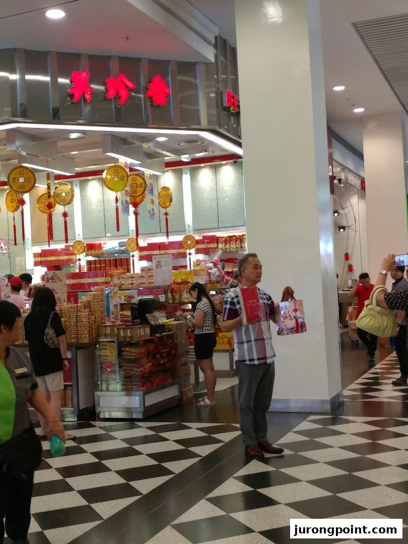 Interior view of Bee Cheng Hiang, showcasing traditional Chinese snacks and customers browsing.