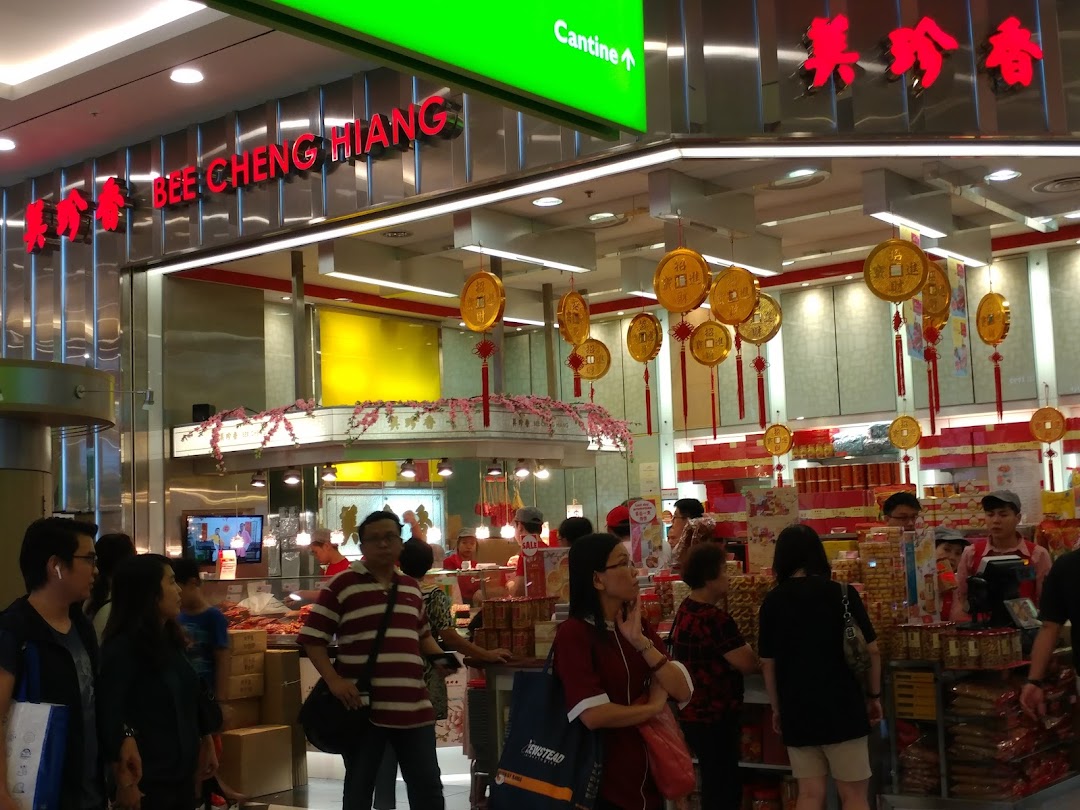 A bustling interior view of Bee Cheng Hiang, showcasing traditional snacks and customers browsing products.